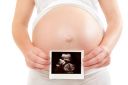 pregnant-woman-holding-ultrasound.jpg